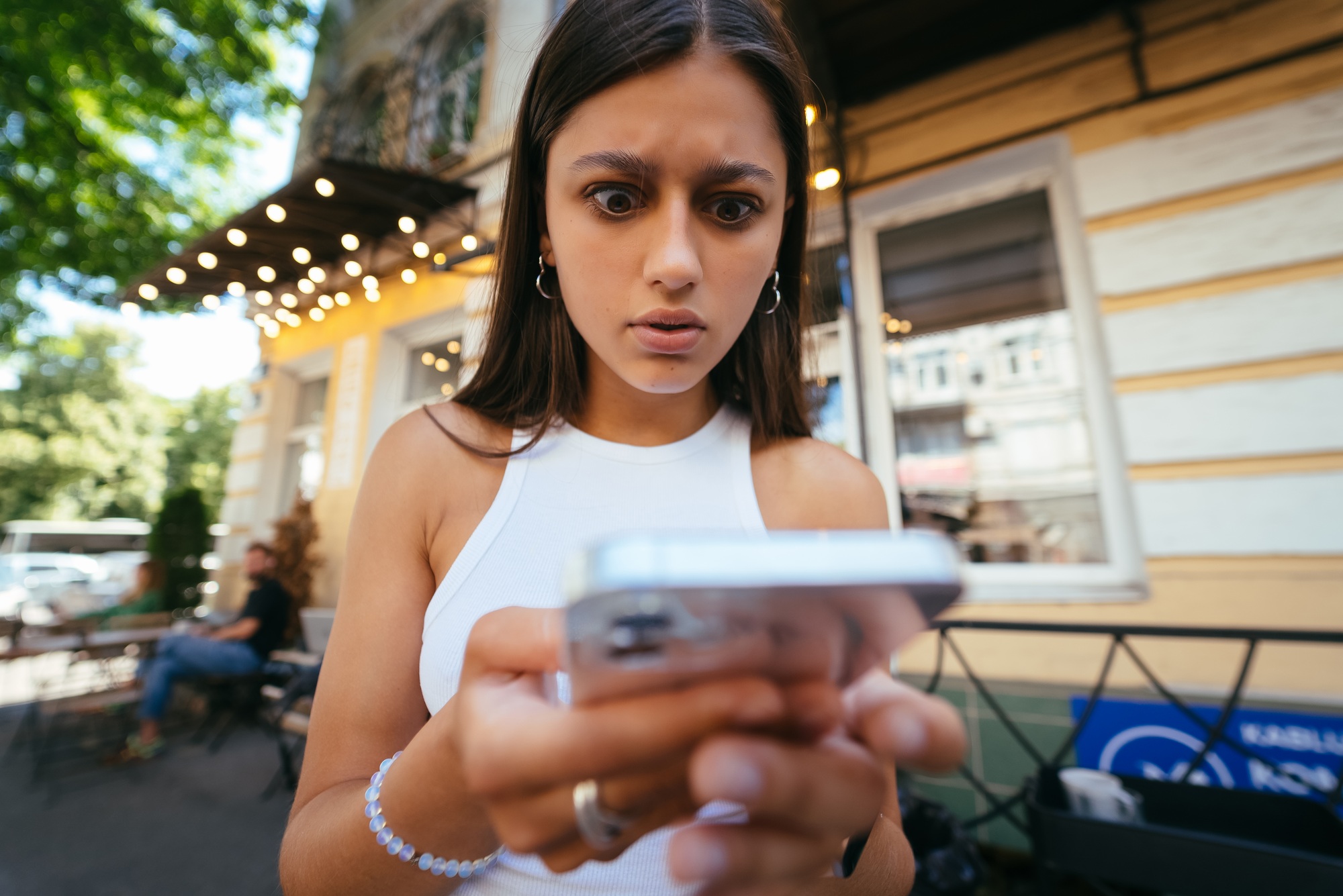 Pretty woman an urban street to read an sms on her mobile phone