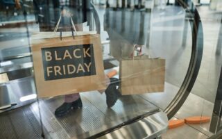 Woman Holding Black Friday Shopping Bags
