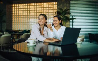 Two besties sitting together in a coffee shop