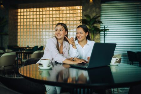 Two besties sitting together in a coffee shop
