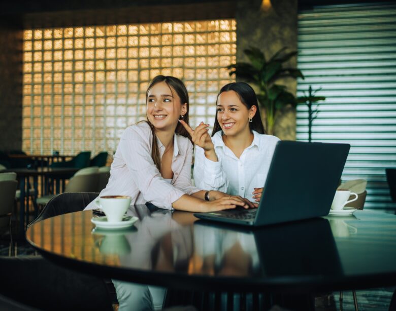 Two besties sitting together in a coffee shop